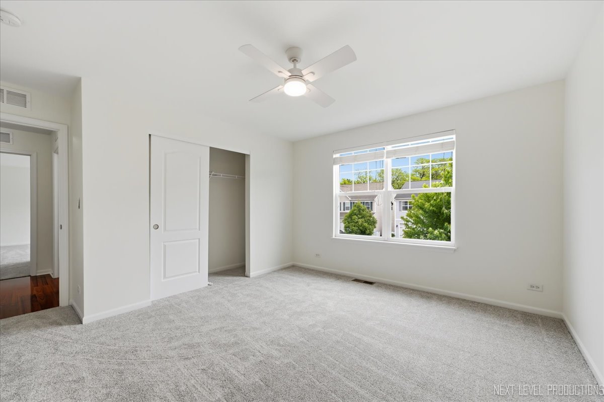 5734 Oak Ridge Way Lisle, IL 60532 - Photo 28 of 33 an empty room with windows and closet