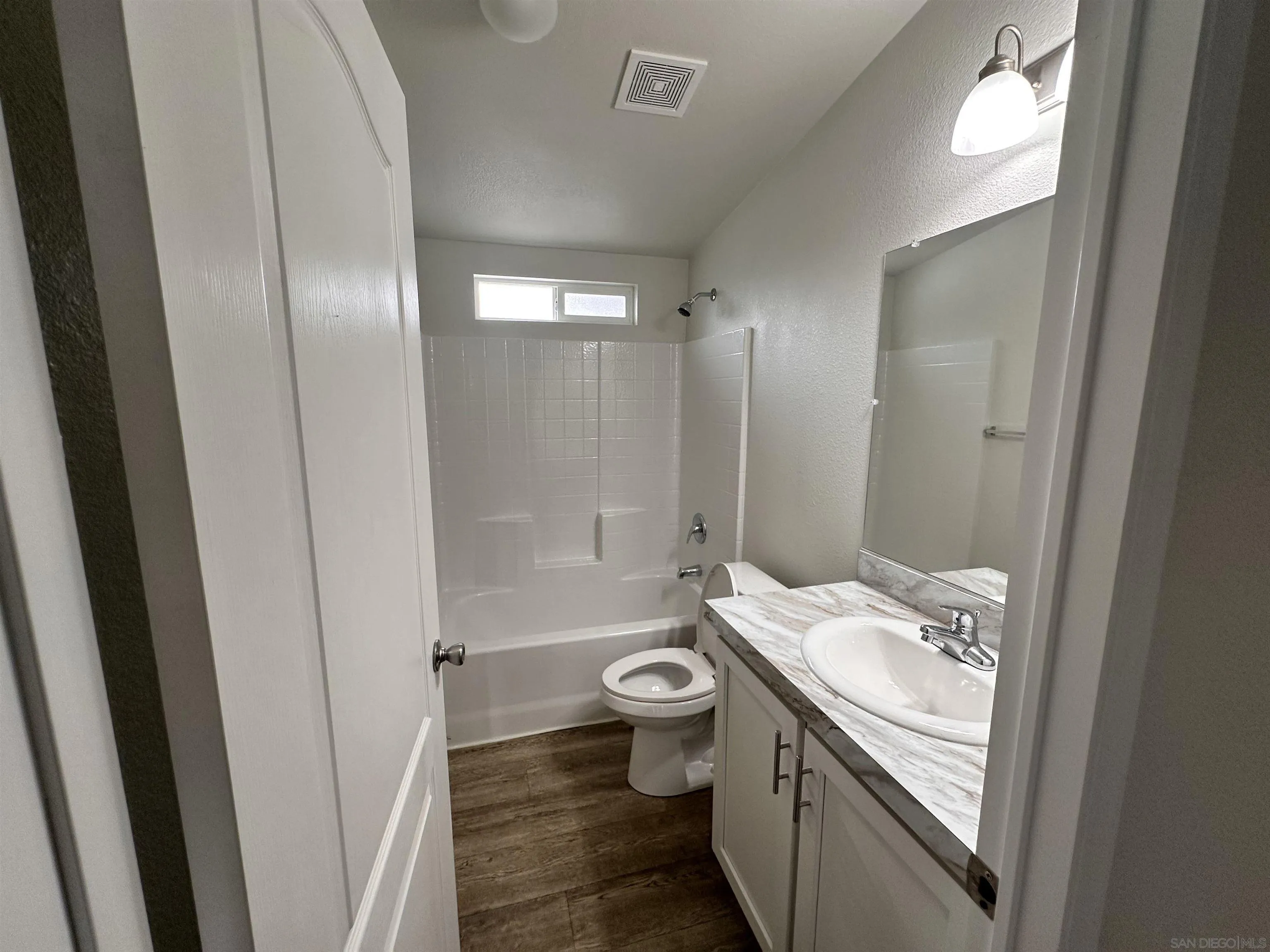 22899 Byron Road, Unit 29 Crestline, CA 92325 - Photo 4 of 8 a bathroom with a granite countertop sink toilet and shower a mirror