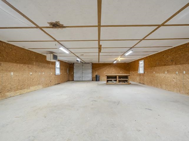 660 Hinton Road Counce, TN 38326 - Photo 39 of 40 Spacious garage with concrete flooring, wood-finish wall panels, and overhead fluorescent lighting