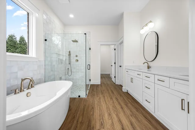 a bathroom with a granite countertop double vanity sink and a mirror