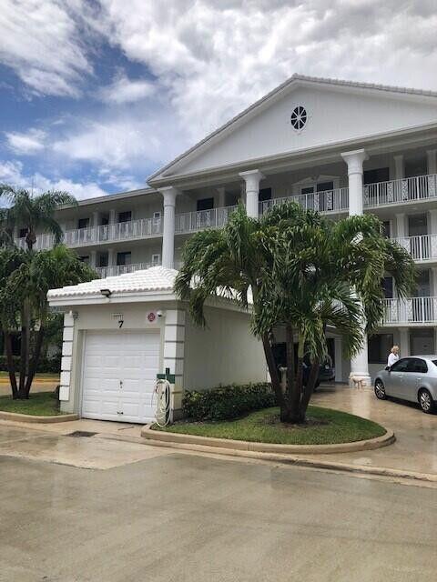 front view of house with a bench and a yard