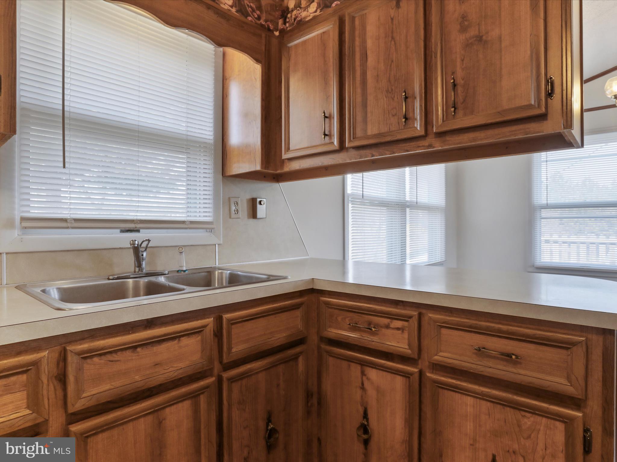 101 Carvers Way Falling Waters, WV 25419 - Photo 12 of 37 a kitchen with granite countertop cabinets sink and window