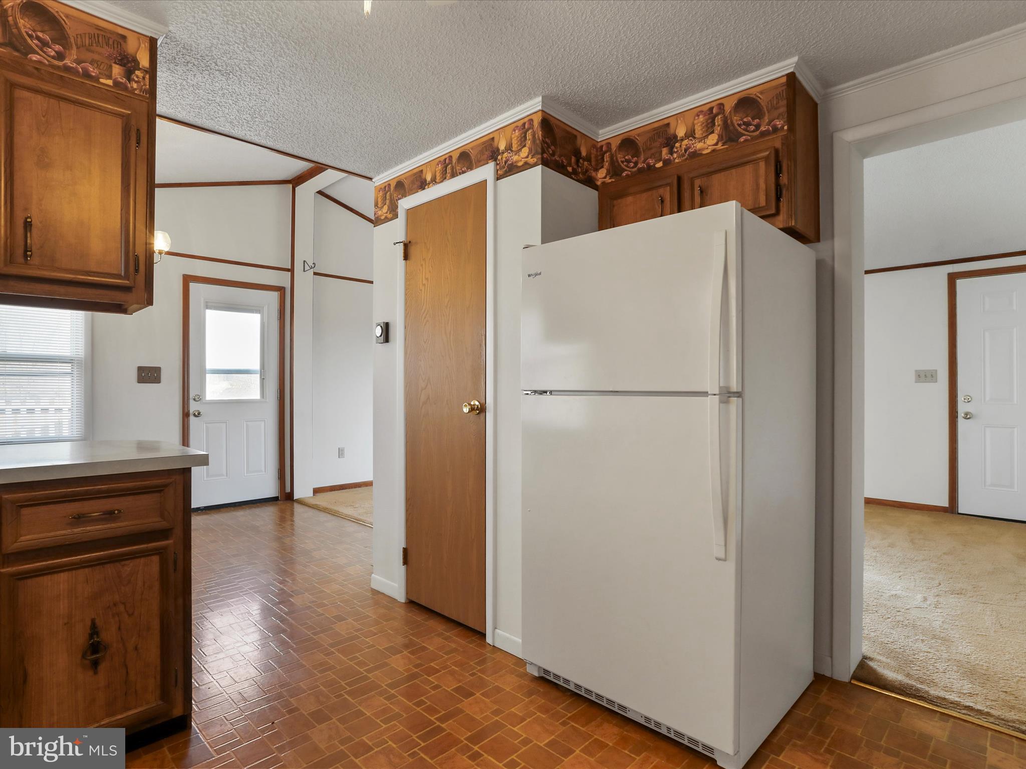 101 Carvers Way Falling Waters, WV 25419 - Photo 13 of 37 a white refrigerator freezer and a stove sitting inside of a kitchen