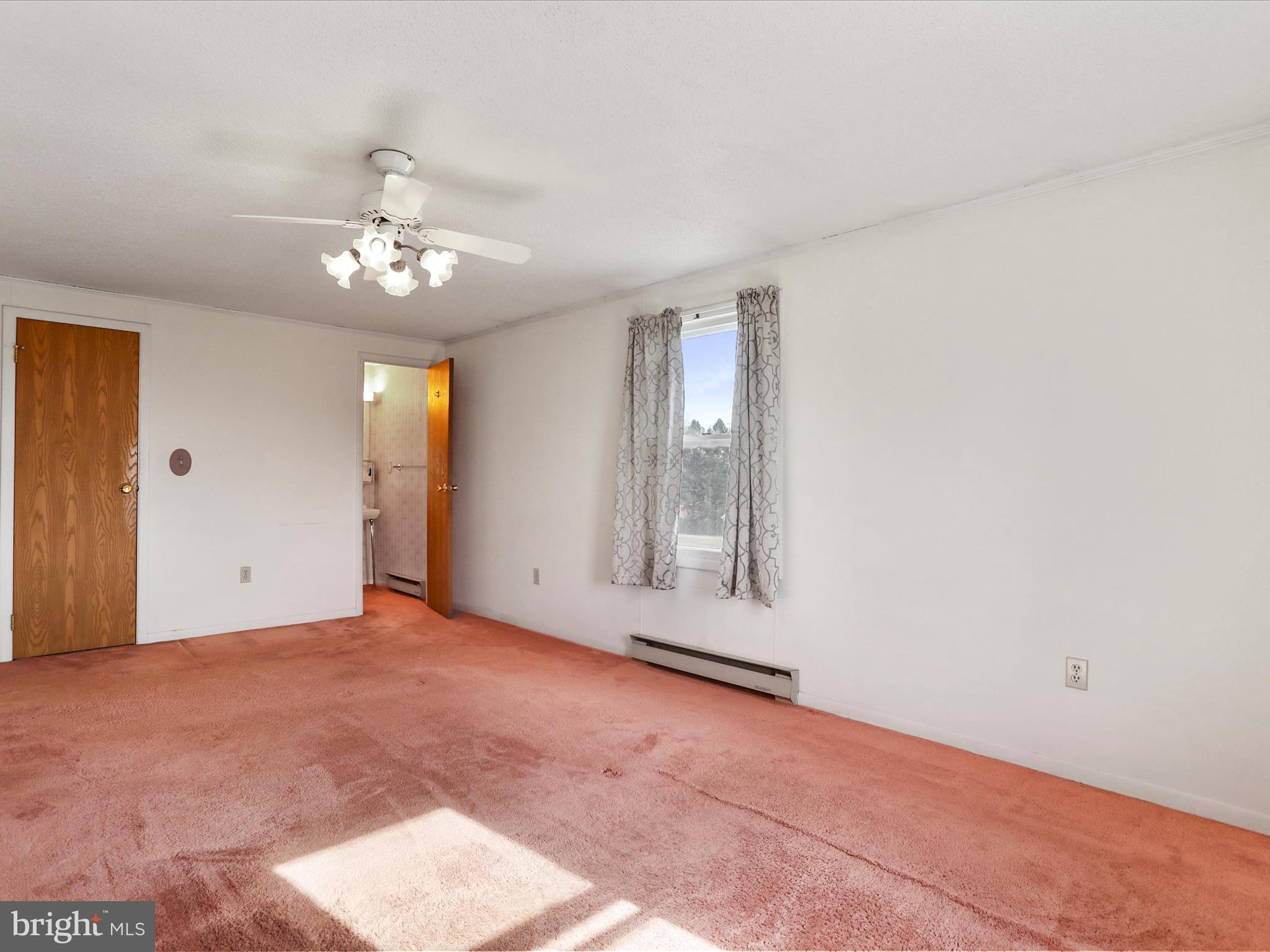 101 Carvers Way Falling Waters, WV 25419 - Photo 16 of 37 an empty room with chandelier fan and windows