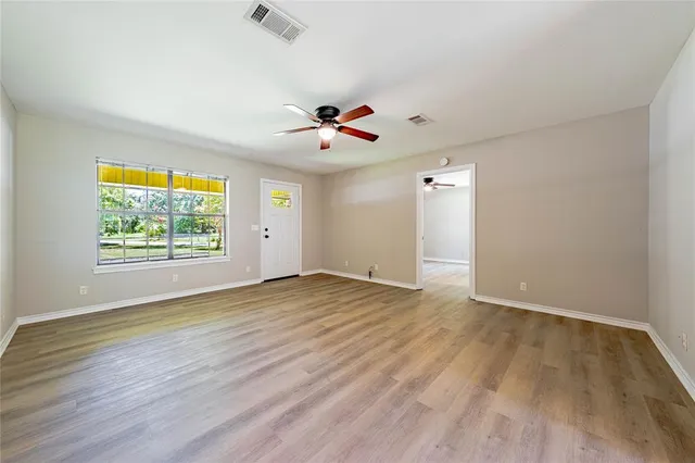 wooden floor in an empty room with a window