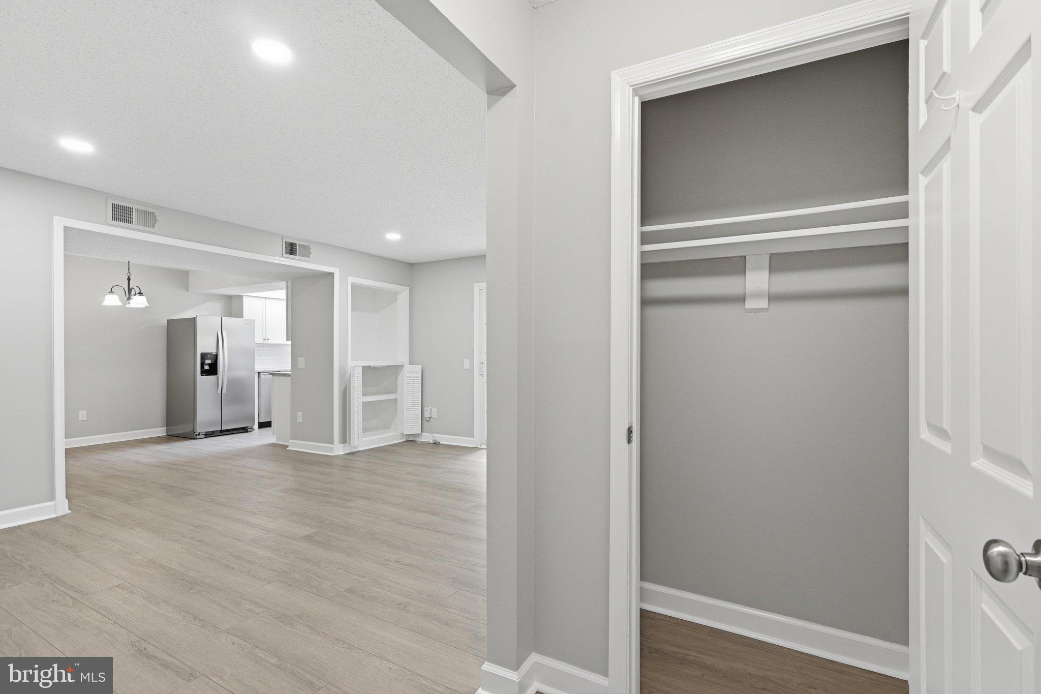 115 Fort Evans Road Southeast, Unit A Leesburg, VA 20175 - Photo 5 of 32 Entryway Coat Closet leading into the Family Room