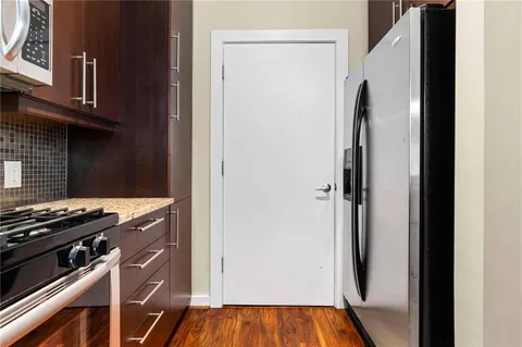 a view of a kitchen with refrigerator and stove