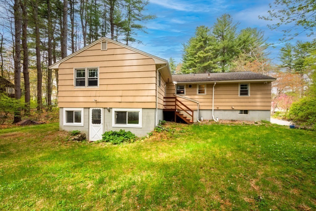 4 Duggan Road Acton, MA 01720 - Photo 20 of 21 a front view of a house with a yard