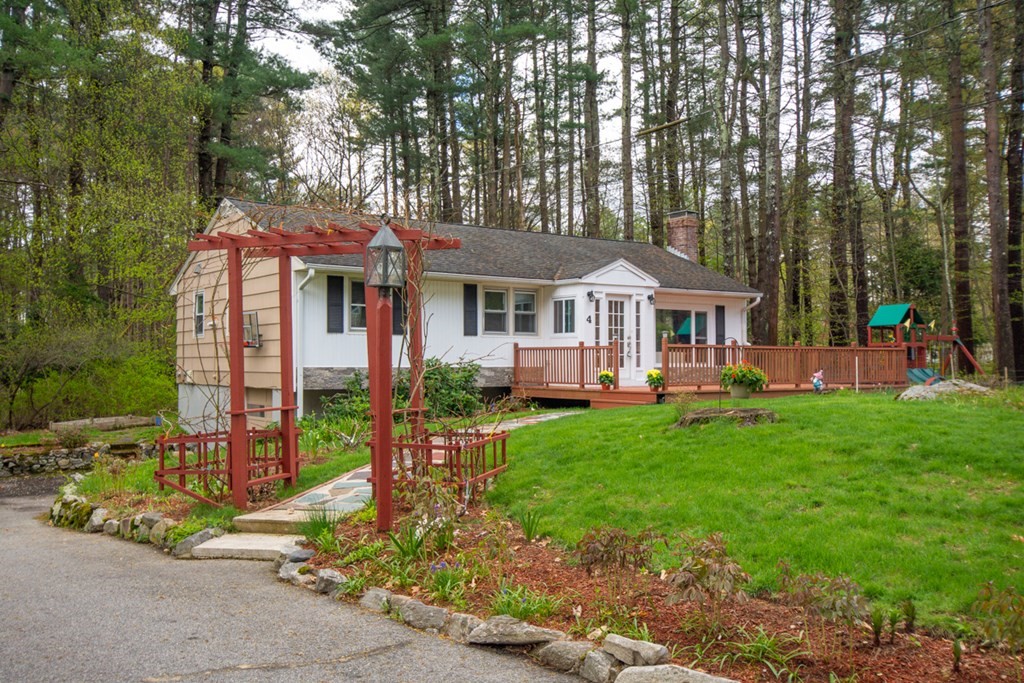 4 Duggan Road Acton, MA 01720 - Photo 2 of 21 a front view of a house with a yard table and chairs