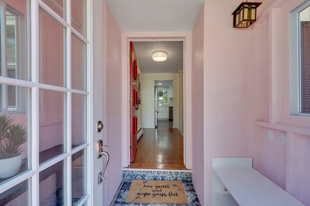 4 Duggan Road Acton, MA 01720 - Photo 3 of 21 a view of a hallway with wooden floor and a livingroom