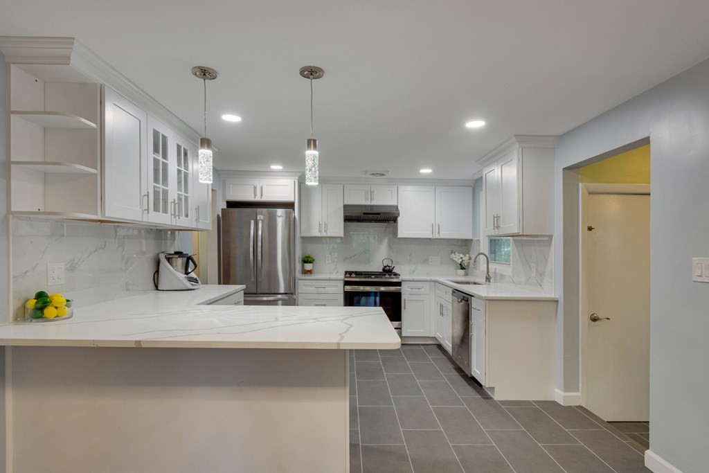 4 Duggan Road Acton, MA 01720 - Photo 7 of 21 a kitchen with stainless steel appliances granite countertop a sink a stove and a refrigerator