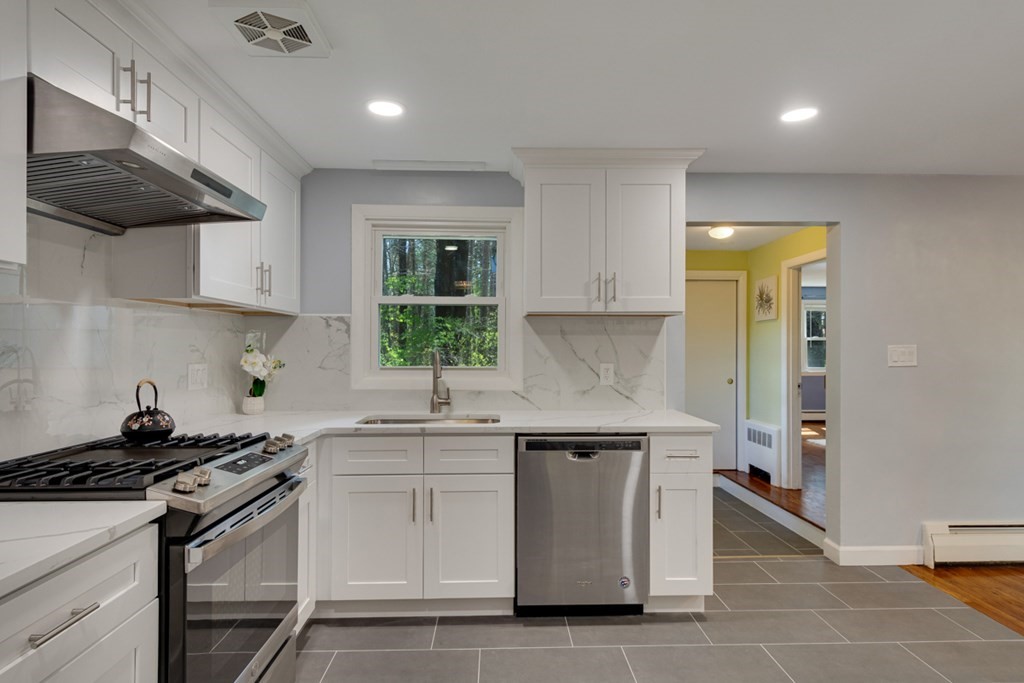 4 Duggan Road Acton, MA 01720 - Photo 8 of 21 a kitchen with stainless steel appliances a sink stove and cabinets