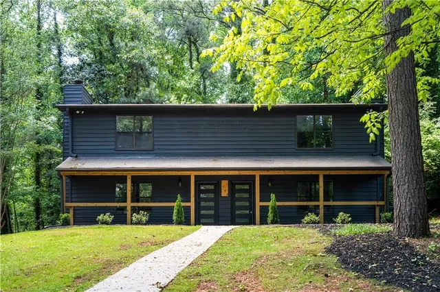 a view of a house with a yard and large window