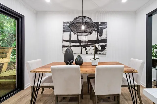 a view of a dining room with furniture window and wooden floor