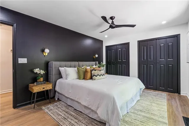 a bedroom with a bed and wooden floor