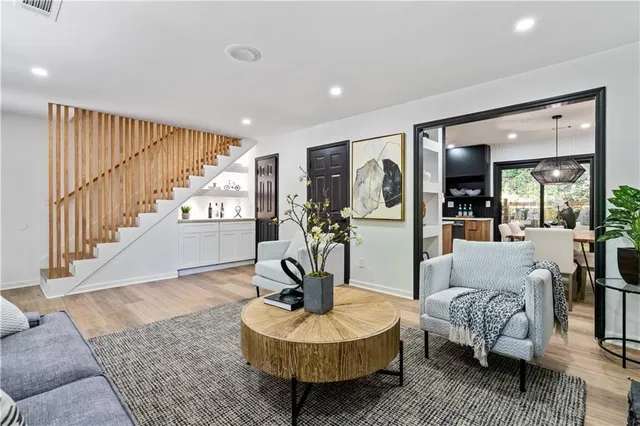 a living room with furniture and a wooden floor