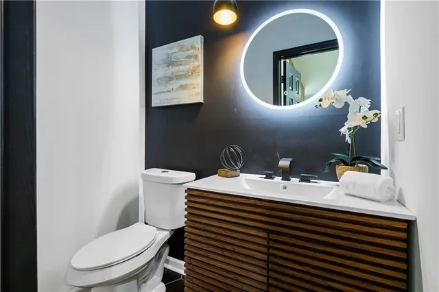 a bathroom with a toilet a sink and mirror