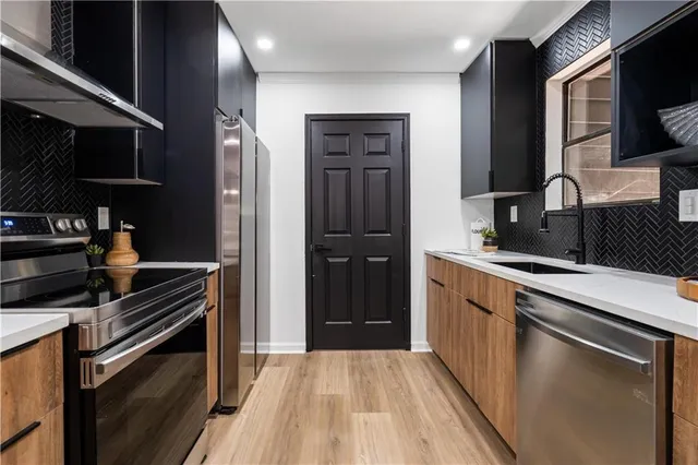 a kitchen with a refrigerator and a sink
