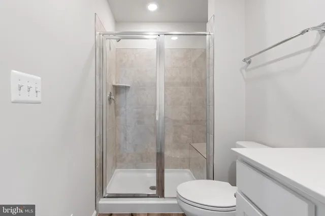 a bathroom with a toilet and a shower