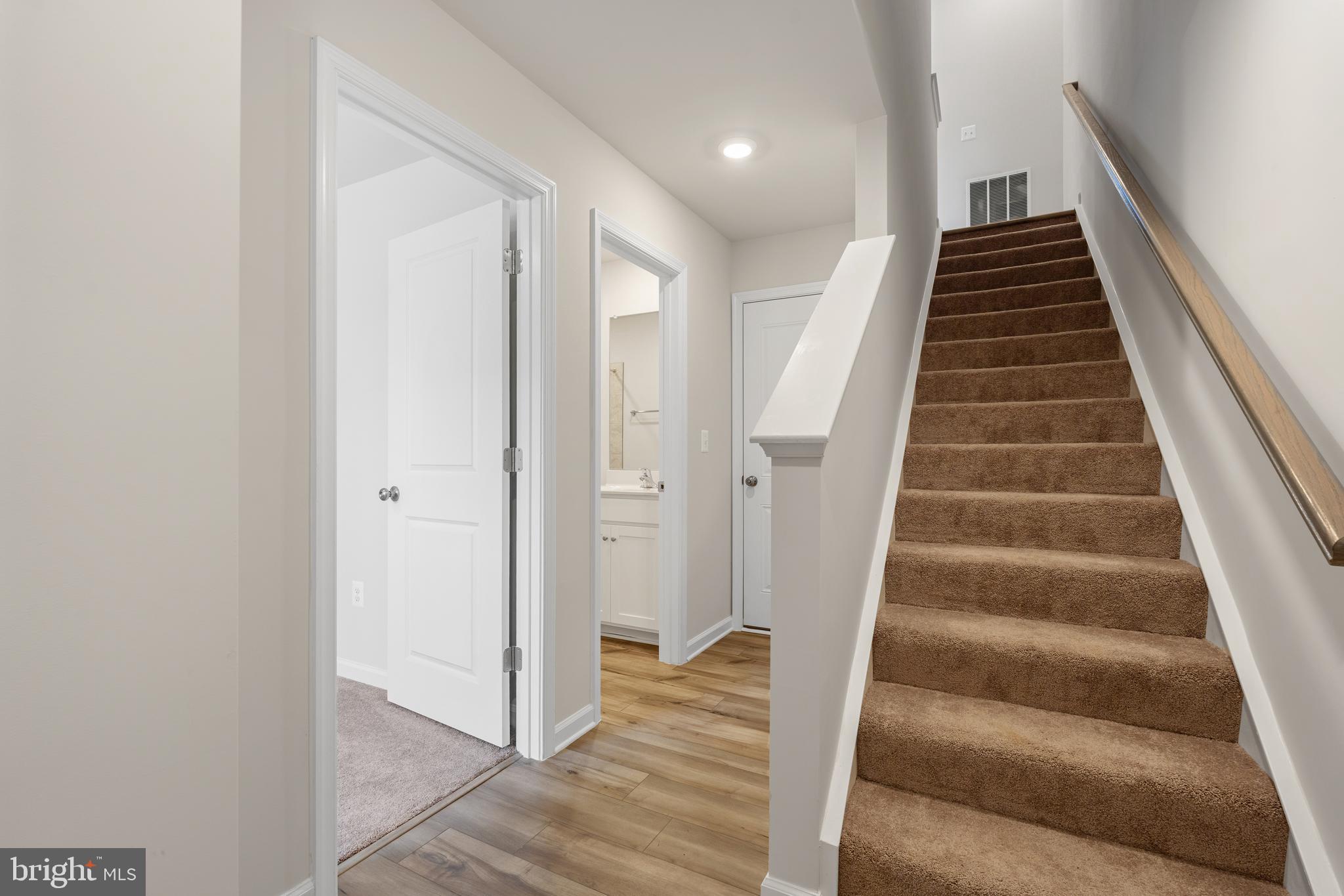 271 Sandy Btm Circle Ranson, WV 25438 - Photo 17 of 25 a view of staircase with wooden floor and white walls
