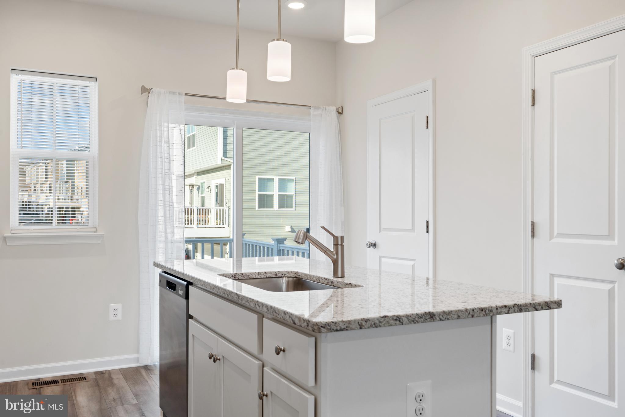 271 Sandy Btm Circle Ranson, WV 25438 - Photo 3 of 25 a kitchen with granite countertop a sink and a window