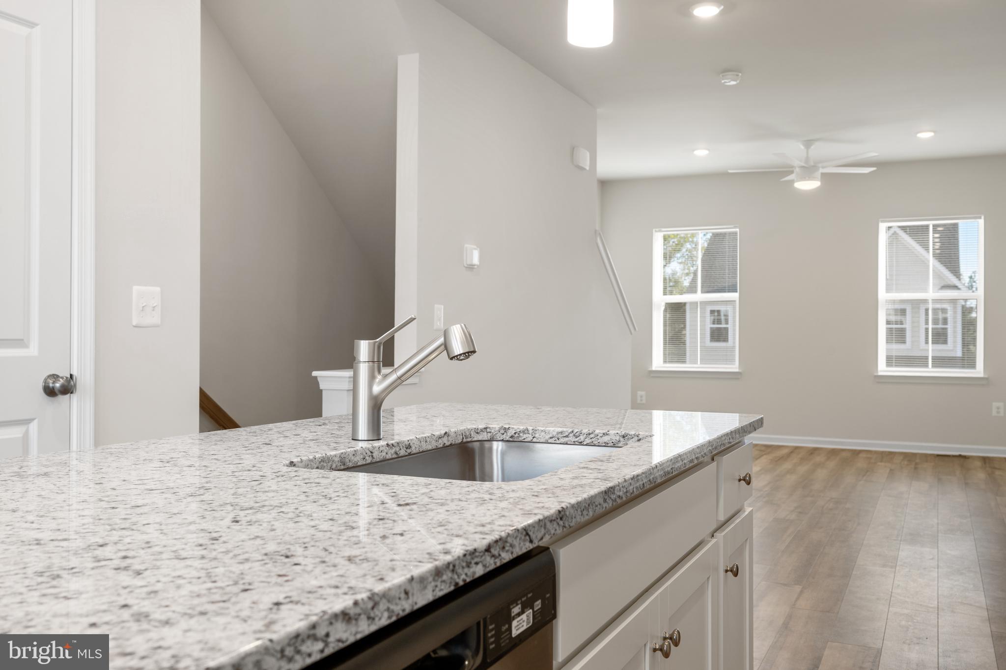 271 Sandy Btm Circle Ranson, WV 25438 - Photo 4 of 25 a kitchen with granite countertop a sink and a white wooden cabinets