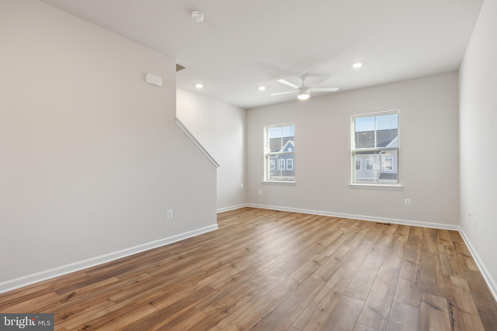 271 Sandy Btm Circle Ranson, WV 25438 - Photo 6 of 25 an empty room with wooden floor and windows