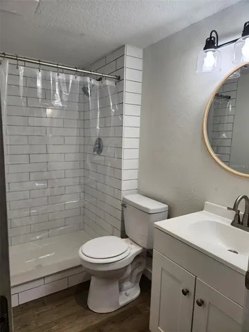 a bathroom with a toilet a sink and shower