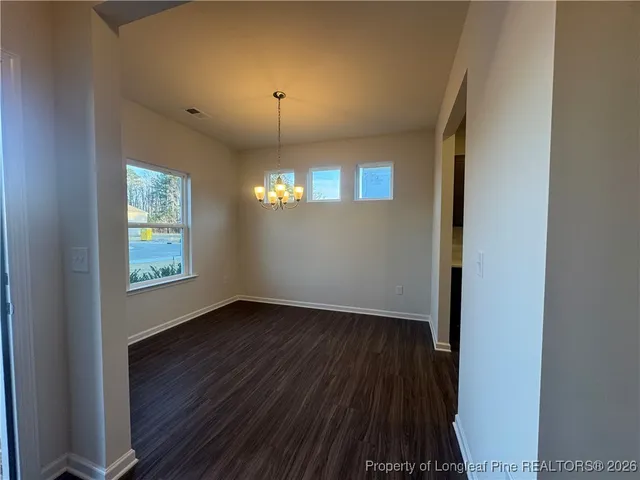 a view of a room with wooden floor and windows