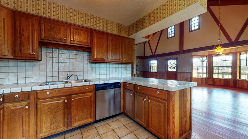 19803 Reading Road Lutz, FL 33558 - Photo 28 of 48 a kitchen with stainless steel appliances granite countertop wooden cabinets a sink and dishwasher