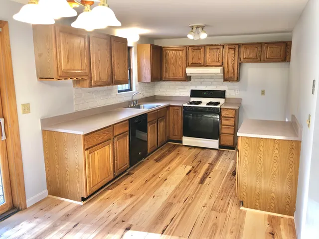 a kitchen with granite countertop a stove and a sink