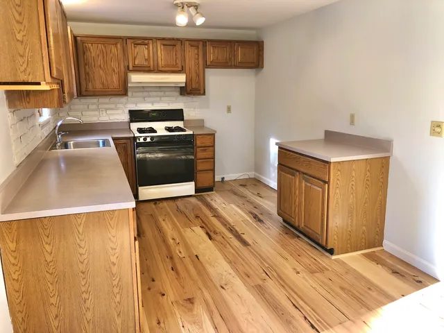 a stove top oven sitting inside of a kitchen