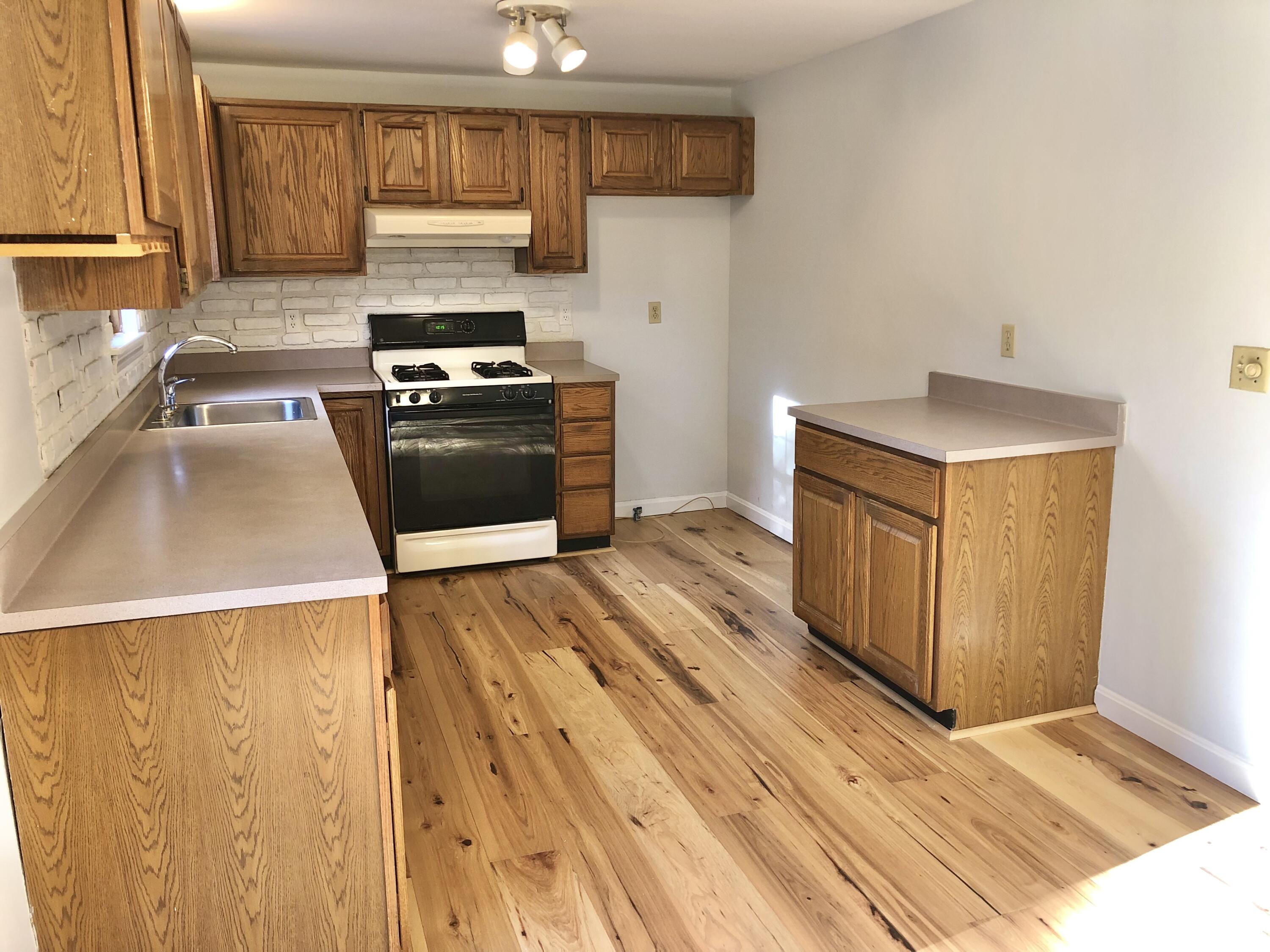 5 Conaumet Road Marstons Mills, MA 02648 - Photo 19 of 44 a kitchen with granite countertop a stove and a sink