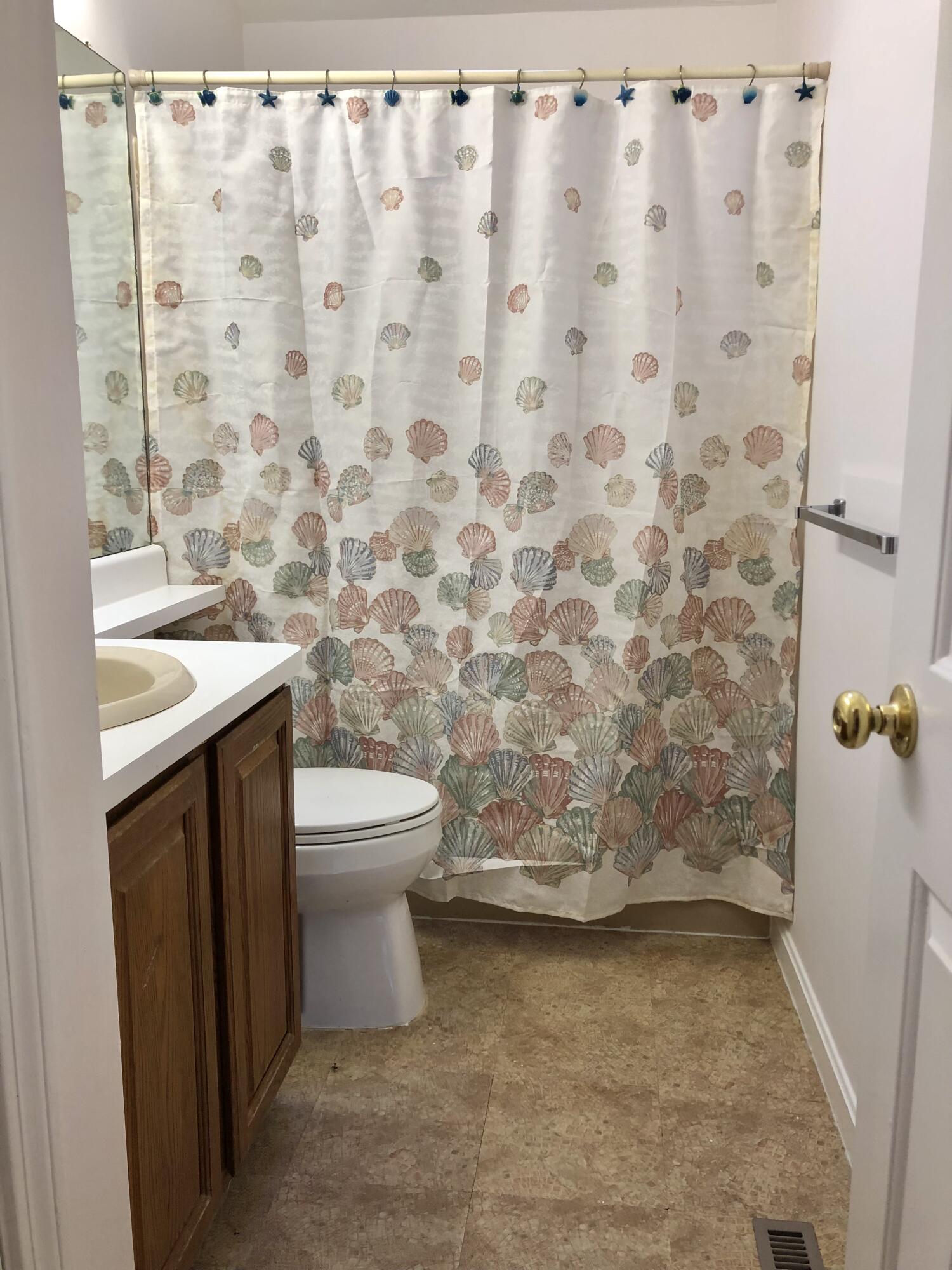 5 Conaumet Road Marstons Mills, MA 02648 - Photo 26 of 44 a bathroom with a toilet and a shower curtain