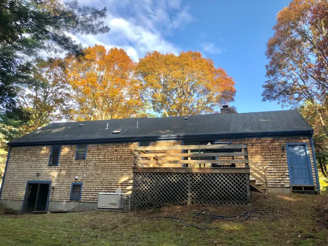 a backyard of a house with a barbeque