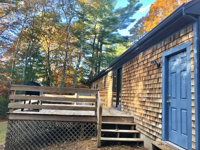 a view of backyard with deck and wooden floor
