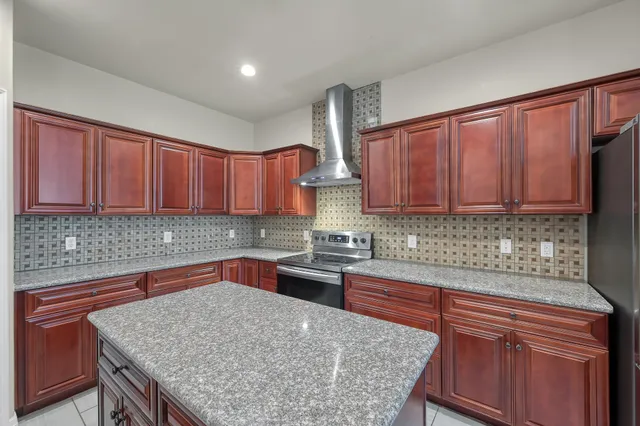 a front view of a house with a garden and plants
