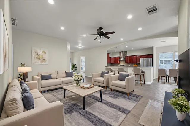 a bathroom with a granite countertop double vanity sink a mirror and a shower