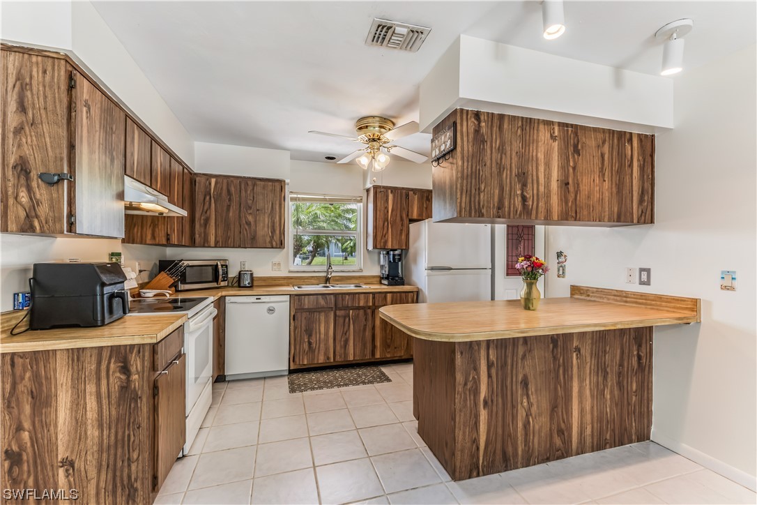 18454 Geranium Road Fort Myers, FL 33967 - Photo 8 of 17 a kitchen with a sink appliances and cabinets