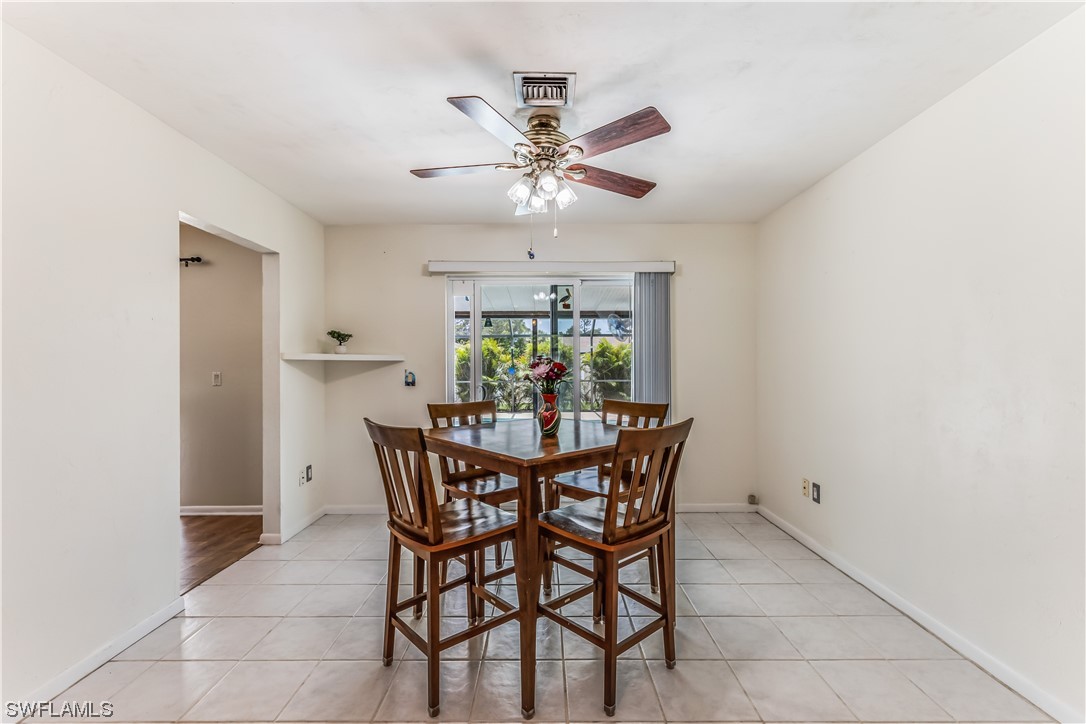 18454 Geranium Road Fort Myers, FL 33967 - Photo 10 of 17 a view of a dining room with furniture and a chandelier fan