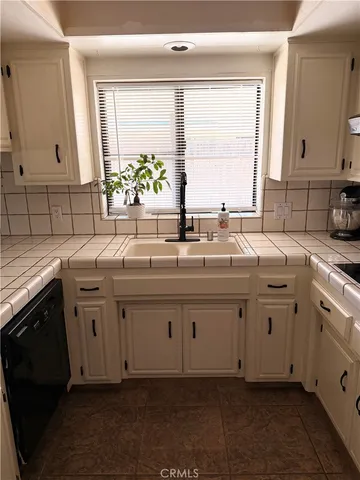 a kitchen with sink cabinets and window