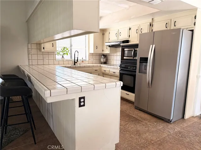 a kitchen with stainless steel appliances a refrigerator and a stove