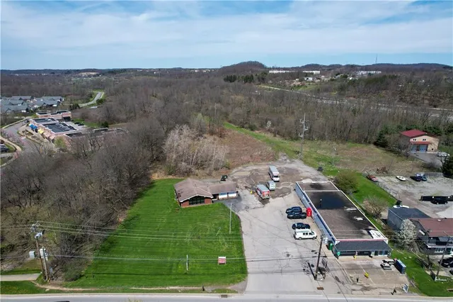 an aerial view of a forest with houses