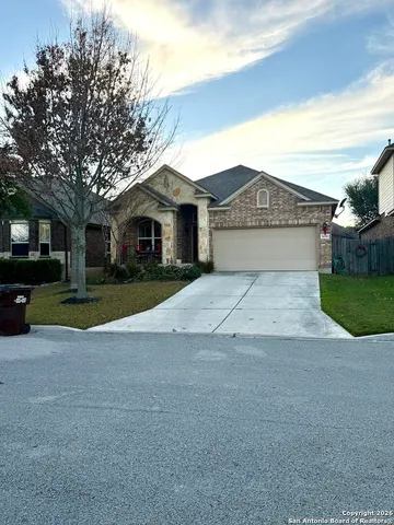 a view of house with yard and large trees