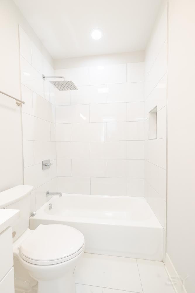 1232 South Fairfield Avenue, Unit 2 Chicago, IL 60608 - Photo 8 of 10 a bathroom with a bathtub and a toilet