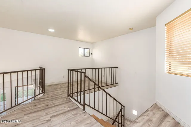 a view of staircase with railing and a window