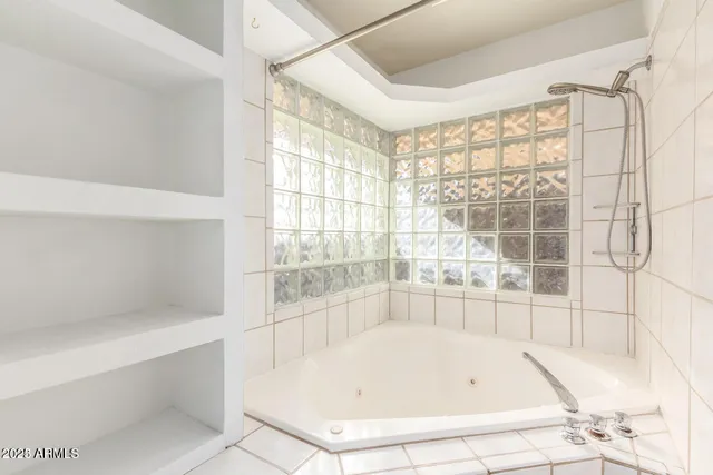 a bathroom with bathtub and window