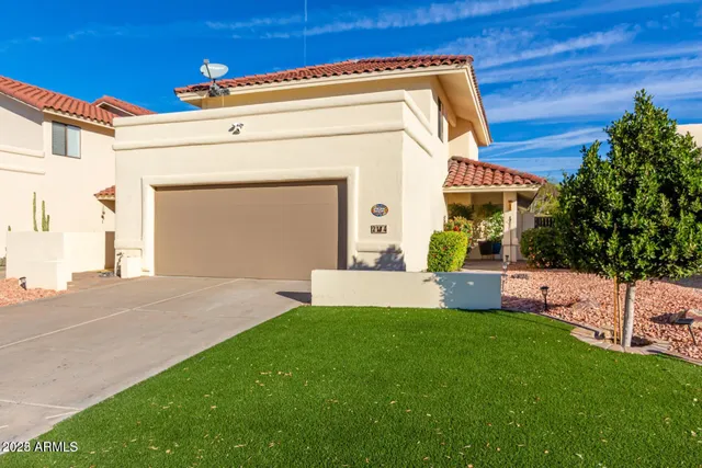 a front view of a house with a yard and trees