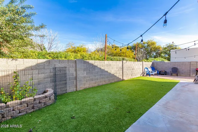 a view of a backyard with wooden fence
