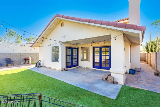 a view of a house with a yard porch and a floor to ceiling window